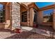 Charming front entrance showcasing a stone column, pathway, and large windows for natural light at 1926 W Wayne Ln, Anthem, AZ 85086