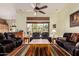 Bright living room featuring comfortable seating, ceiling fan, and window with outside views at 1926 W Wayne Ln, Anthem, AZ 85086