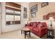 Cozy living room with a red sofa and a view of the backyard at 1926 W Wayne Ln, Anthem, AZ 85086