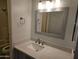 Bathroom with vanity, quartz countertop, and sink below mirror and decorative light fixture at 2220 W Dora St # 114, Mesa, AZ 85201