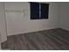 The main bedroom offers gray flooring, white walls, and a window with black curtains at 2220 W Dora St # 114, Mesa, AZ 85201