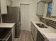 Well-lit kitchen with stainless steel refrigerator, grey cabinets, and lots of counter space at 2220 W Dora St # 114, Mesa, AZ 85201