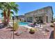 Backyard paradise featuring a pool, lounging area, and desert landscaping at 22338 N O Sullivan Dr, Maricopa, AZ 85138