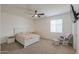 Bedroom with neutral walls, ceiling fan, large bed, window, and chair at 22338 N O Sullivan Dr, Maricopa, AZ 85138