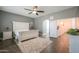 Neutral primary bedroom boasts tile floors, ceiling fan, and access to ensuite bath at 22338 N O Sullivan Dr, Maricopa, AZ 85138