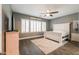 Relaxing bedroom features tile floors, neutral paint, ceiling fan, and shuttered windows at 22338 N O Sullivan Dr, Maricopa, AZ 85138