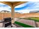 Covered back patio with barbeque and view of a large fenced backyard with pavers and artifical turf at 2376 E Rosario Mission Dr, Casa Grande, AZ 85194