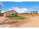 Expansive dirt backyard, enclosed by a tall brick wall, offering a patio and small artifical turf at 2376 E Rosario Mission Dr, Casa Grande, AZ 85194