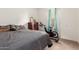 Bedroom featuring neutral carpet, vintage dresser, and small Peloton-like exercise bike at 2376 E Rosario Mission Dr, Casa Grande, AZ 85194