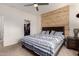 Comfortable bedroom featuring a striking wooden headboard and ceiling fan at 2376 E Rosario Mission Dr, Casa Grande, AZ 85194