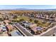 Scenic aerial view of a community with solar-paneled homes, neat landscaping, and mountain backdrop at 23830 W Romley W Ave, Buckeye, AZ 85326