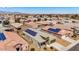 Aerial view of a suburban home with solar panels, surrounded by other homes and desert landscaping at 23830 W Romley W Ave, Buckeye, AZ 85326