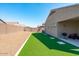 Backyard with artificial turf and gravel, plus covered patio with grill at 23830 W Romley W Ave, Buckeye, AZ 85326