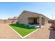 Backyard with gravel and artificial turf plus covered back patio at 23830 W Romley W Ave, Buckeye, AZ 85326