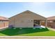 Back exterior view of the home with artificial turf and covered patio at 23830 W Romley W Ave, Buckeye, AZ 85326