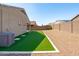 Backyard featuring artificial turf and gravel, plus AC unit at 23830 W Romley W Ave, Buckeye, AZ 85326