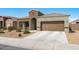 Inviting single-story home with a two-car garage and a tidy, desert-friendly front yard at 23830 W Romley W Ave, Buckeye, AZ 85326