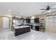 Modern kitchen featuring dark cabinetry, stainless steel appliances, and a large island with granite countertop at 23830 W Romley W Ave, Buckeye, AZ 85326