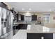 Updated kitchen featuring stainless steel appliances, dark wood cabinets, and a large kitchen island at 23830 W Romley W Ave, Buckeye, AZ 85326