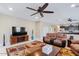 Living room showcasing comfortable seating, an entertainment unit, and a seamless transition to other areas of the home at 23830 W Romley W Ave, Buckeye, AZ 85326