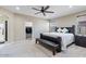 Comfortable main bedroom showcasing a ceiling fan, large windows, and a door to the walk-in closet at 23830 W Romley W Ave, Buckeye, AZ 85326