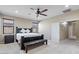 This main bedroom features neutral walls, a ceiling fan, and a door to the bathroom hallway at 23830 W Romley W Ave, Buckeye, AZ 85326