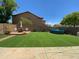 A spacious backyard with lush green grass, above ground pool, brick patio and seating area, perfect for outdoor enjoyment at 2439 W White Feather Ln, Phoenix, AZ 85085