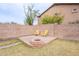 A private backyard with a stone firepit area and plenty of room to entertain guests at 2439 W White Feather Ln, Phoenix, AZ 85085