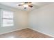 Neutral bedroom with hardwood floors, a ceiling fan, and natural light from window at 2439 W White Feather Ln, Phoenix, AZ 85085