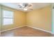 Cozy bedroom features hardwood floors, natural light from window, and ceiling fan at 2439 W White Feather Ln, Phoenix, AZ 85085