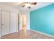 Bedroom features hardwood floors, a closet with sliding doors and ceiling fan at 2439 W White Feather Ln, Phoenix, AZ 85085