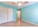 Bedroom features hardwood floors, a closet with sliding doors and ceiling fan at 2439 W White Feather Ln, Phoenix, AZ 85085