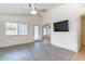 Bright living room with ceiling fan, neutral walls, and durable flooring at 2439 W White Feather Ln, Phoenix, AZ 85085