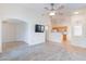 Open-concept living room and kitchen with modern flooring and ceiling fan at 2439 W White Feather Ln, Phoenix, AZ 85085