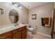 Well-lit bathroom with a spacious vanity, oval mirror, and tile flooring, offering a clean design at 250 W Queen Creek Rd # 146, Chandler, AZ 85248