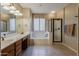 Bright bathroom with a double vanity, soaking tub, and glass-enclosed shower, offering a spa-like experience at 250 W Queen Creek Rd # 146, Chandler, AZ 85248