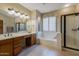 Bright bathroom with a double vanity, soaking tub, and glass-enclosed shower, offering a spa-like experience at 250 W Queen Creek Rd # 146, Chandler, AZ 85248