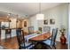 Open-concept dining room with a wood table and view into the kitchen, perfect for gatherings at 250 W Queen Creek Rd # 146, Chandler, AZ 85248