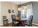 Cozy dining room featuring a wood table with seating, stylish light fixture, and natural light from a large window at 250 W Queen Creek Rd # 146, Chandler, AZ 85248