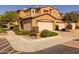 Attractive townhome with a two-car garage, desert landscaping, and well-maintained facade at 250 W Queen Creek Rd # 146, Chandler, AZ 85248