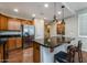 Modern kitchen boasts stainless steel appliances, granite countertops, and a breakfast bar with pendant lighting at 250 W Queen Creek Rd # 146, Chandler, AZ 85248