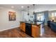 Stylish kitchen island with breakfast bar seating, seamlessly connecting to the dining and living spaces at 250 W Queen Creek Rd # 146, Chandler, AZ 85248