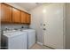 Functional laundry room with matching washer and dryer set, built-in cabinets and tile floors at 250 W Queen Creek Rd # 146, Chandler, AZ 85248