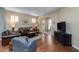 Bright living room featuring hardwood floors, neutral tones, and sliding door access to the patio at 250 W Queen Creek Rd # 146, Chandler, AZ 85248