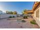 Spacious backyard with mature plants, gravel, and block wall at 2512 N Central Dr, Chandler, AZ 85224