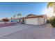 Charming single-story home with a two-car garage, desert landscaping, and palm trees at 2512 N Central Dr, Chandler, AZ 85224