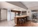 Kitchen with white appliances, breakfast bar and wood cabinetry; providing ample space for meal prep and casual dining at 2512 N Central Dr, Chandler, AZ 85224