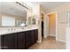 Bright bathroom featuring a double sink vanity, framed mirrors, and tile floors at 2748 W Sunland Ave, Phoenix, AZ 85041