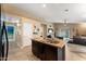 Stylish kitchen island with granite countertop, dark cabinetry, and an open layout to the living space at 2748 W Sunland Ave, Phoenix, AZ 85041