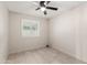 Bedroom with tile floor, ceiling fan, neutral colored walls, and white window shutters at 302 W Thunderbird Rd, Phoenix, AZ 85023